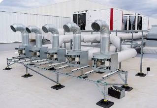Row of commercial rooftop package units (RTUs) with ductwork manifold installed by Albos HVAC